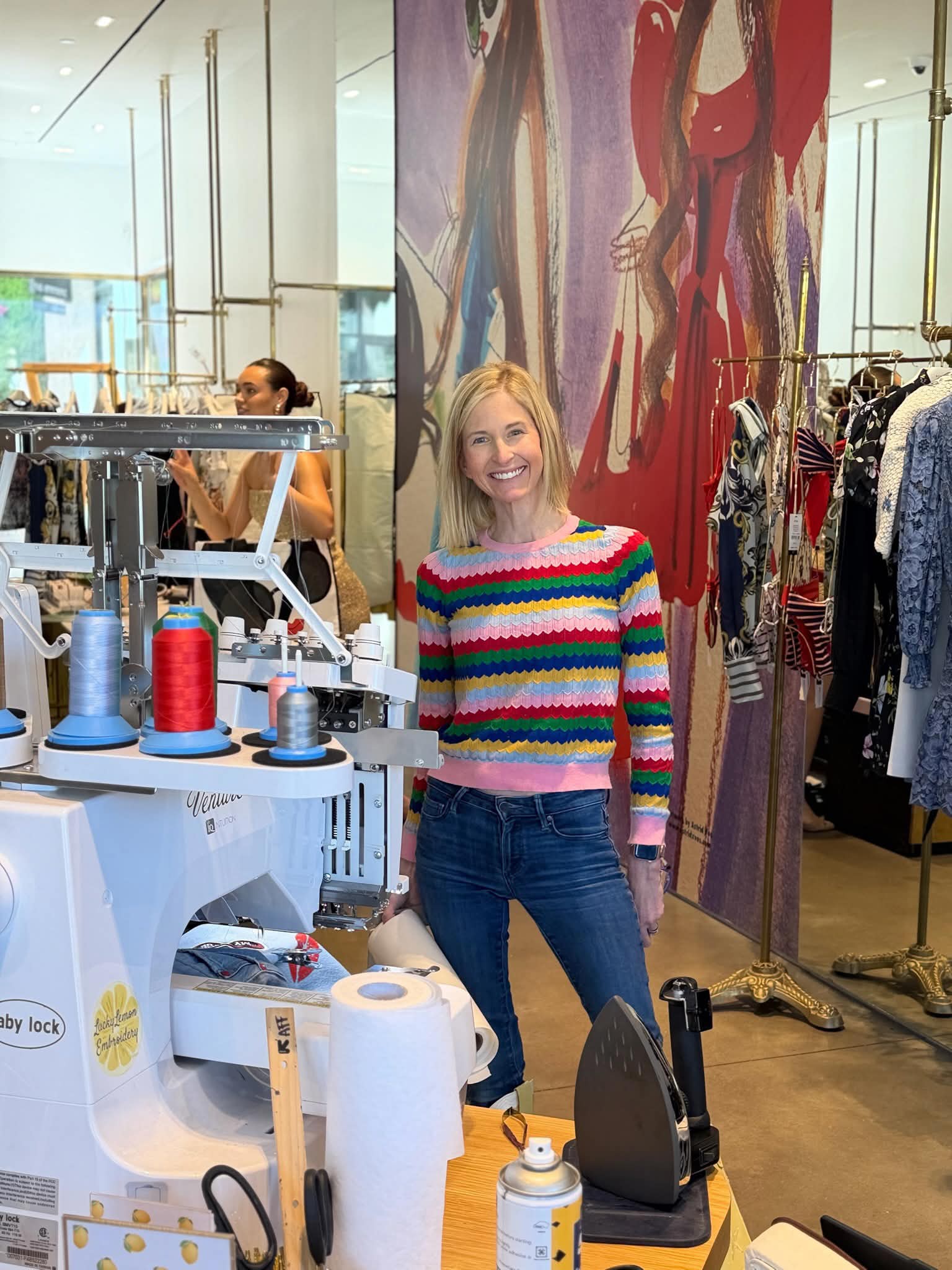 Emily stitching at an on-site mall event