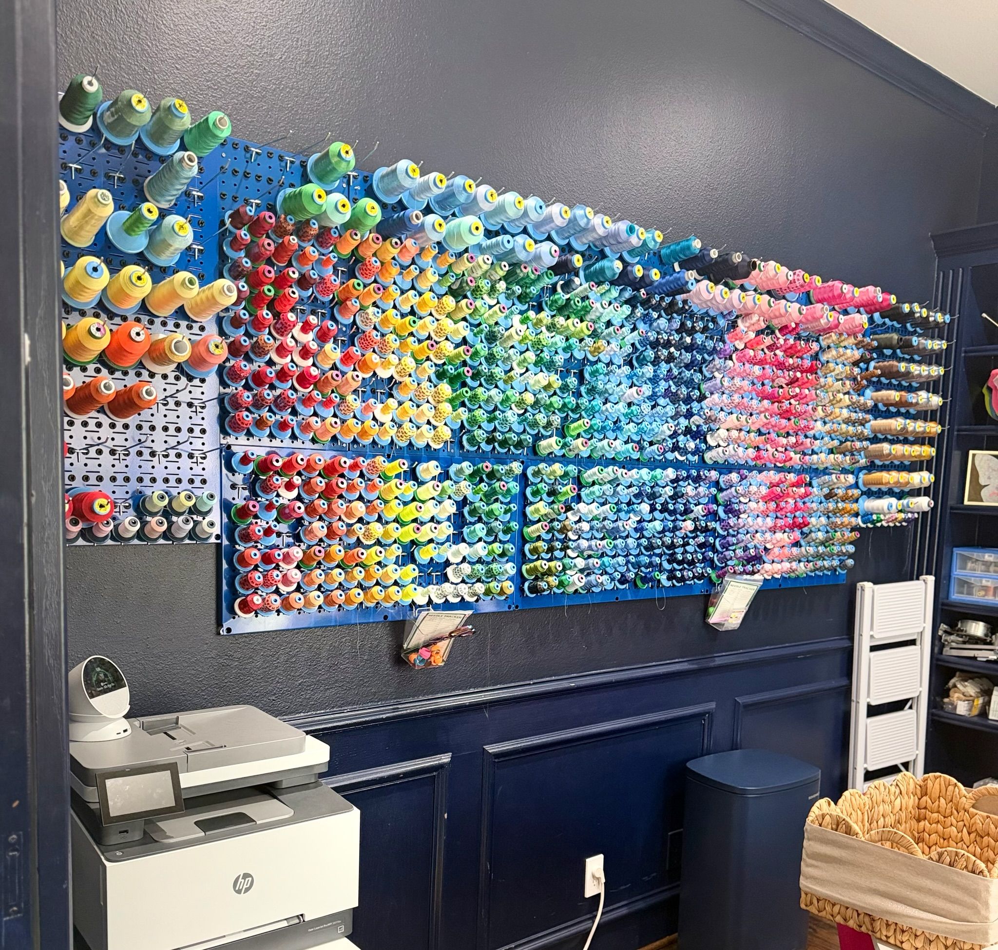 The Lucky Lemon studio — embroidery thread organized as a rainbow wall
